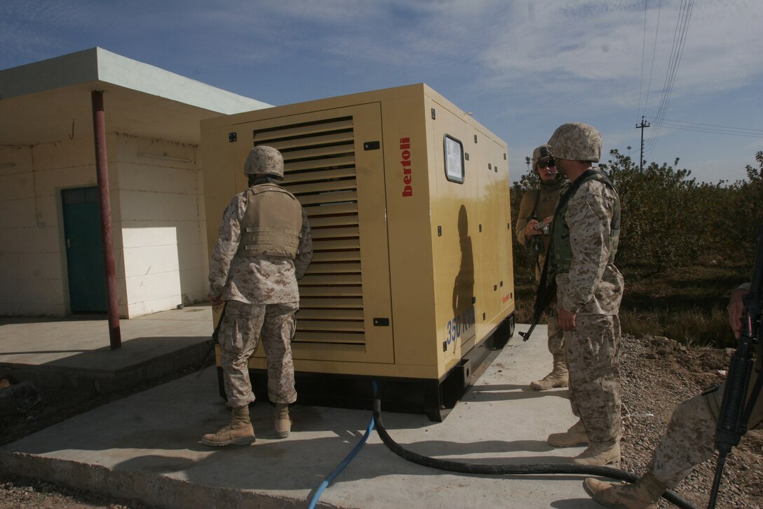Marines from Team 4, Detachment 4, 6th Civil Affairs Group, 2nd Marine Division, inspect a water plant that was recently opened in Fallujah.  More than 80% of the city has water service today.  Coalition forces have repaired the primary water treatment plant and are constructing two others.