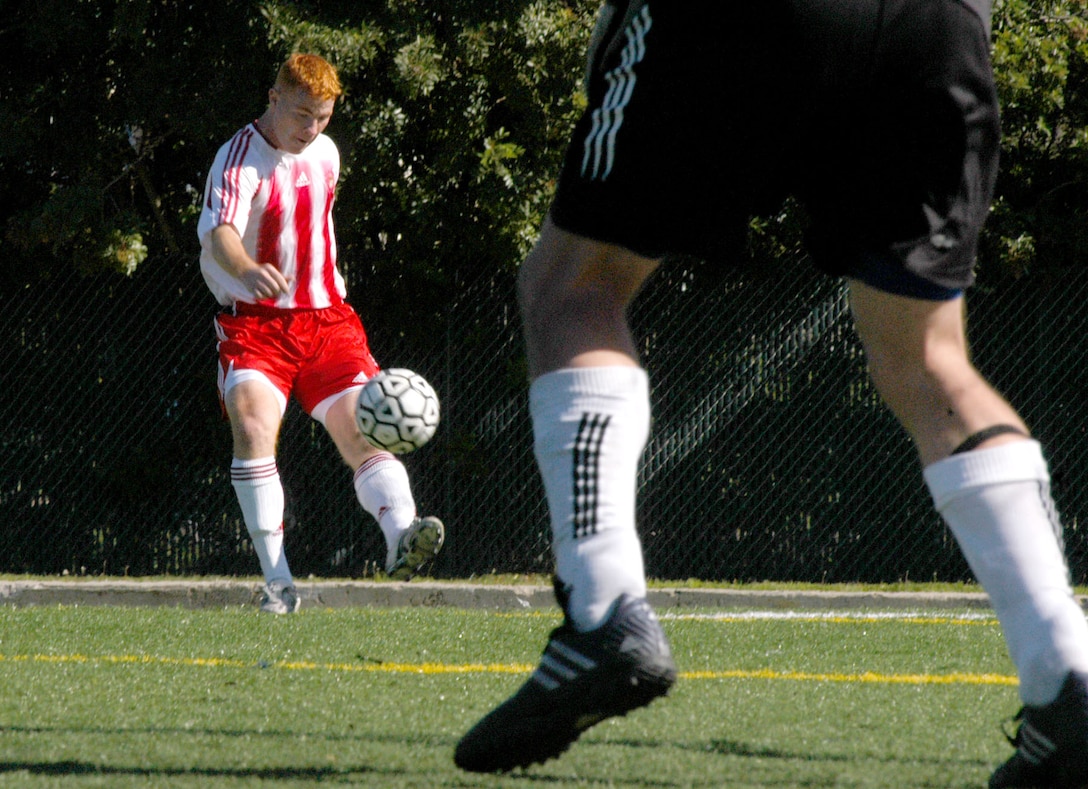 Cpl. Casey Vincent kicks the ball from the corner back into play after an airmen put the ball out of play.