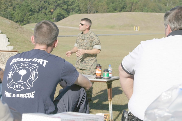 Beaufort firefighters and police officers listen as Staff Sgt. Jules Thompson, an explosive ordnance disposal technician for Marine Corps Air Station Beaufort, teaches them about explosives at the EOD range here, Nov. 4.