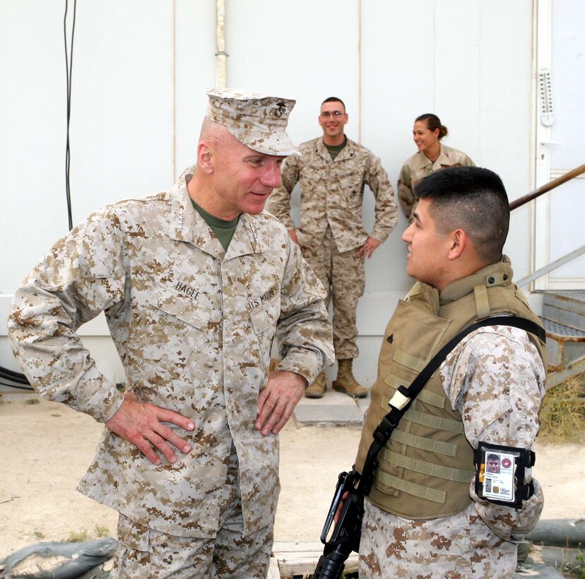 Commandant of the Marine Corps Gen. Michael W. Hagee talks to Cpl. Ceasar Hidalgo at Ali Al Salem, Kuwait, April 4. According to the MARCENT, Kuwait administrative clerk, meeting the commandant is a highlight in his career. The Commandant and Sgt. Maj. of the Marine Corps spent their time talking to the MARCENT Coordination Element Marines before continuing their trip to Iraq.