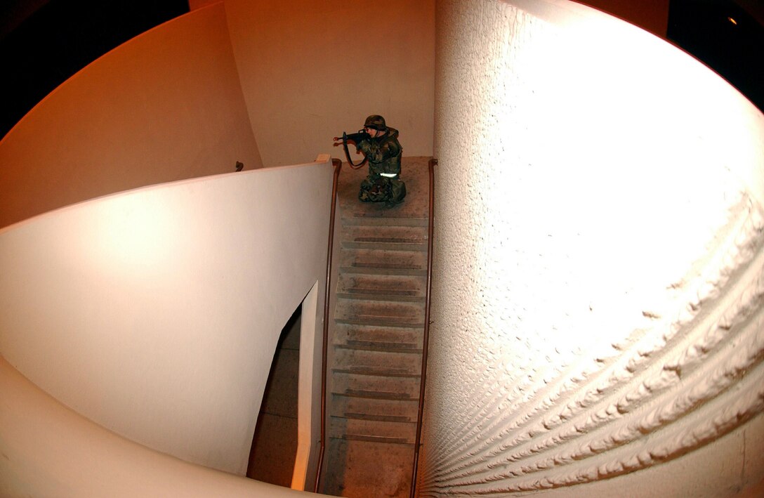 OSAN AIR BASE, South Korea -- Staff Sgt. Tim Westerland uses tactical maneuvers to conduct a sweep of the grounds at the base hospital after a simulated fire fight here recently during Exercise Beverly Midnight. The Airman is assigned to the 51st Security Forces Squadron. ( U.S. Air Force photo by Airman 1st Class Kristi Mulder)
 

