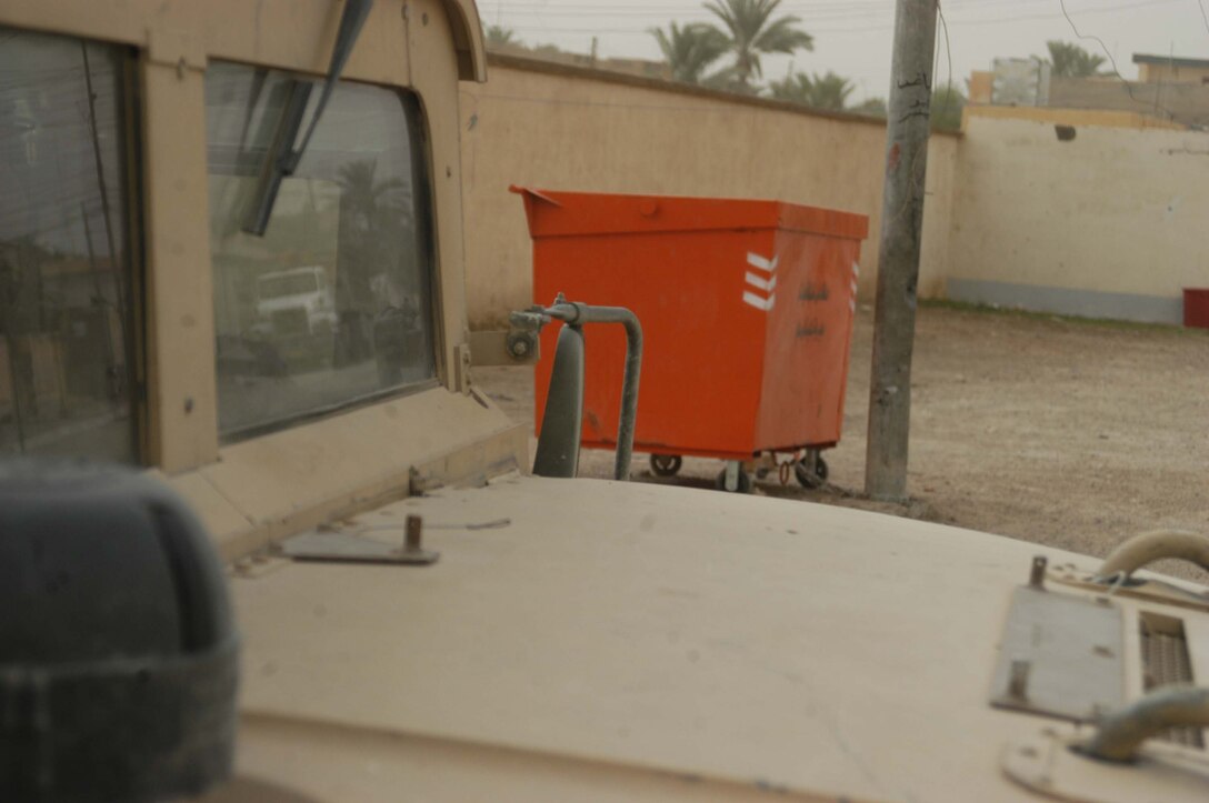AR RAMADI Iraq (July 5, 2005) -Orange, industrial-sized trashcans like this one are all over the Al Anbar capital city. The Iraqi government recently distributed new trash containers throughout the city for citizens to use to clean up rubbish, but Marine officials with the 1st Battalion, 5th Marines suspect insurgents will exploit them for terror and place improvised explosive devices in them. Positioned alongside roads, they pose a threat to military convoys traveling about the city. Photo by: Cpl. Tom Sloan