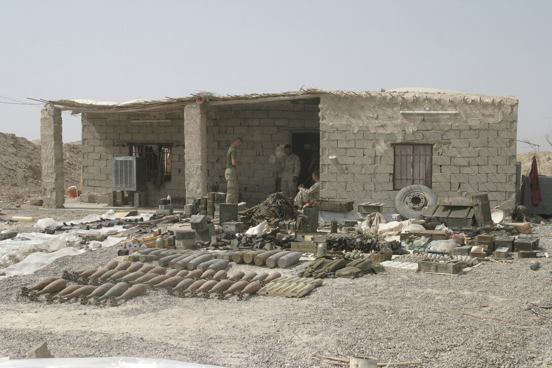 NORTHERN SECURITY ZONE, Iraq (June 05, 2005) - While conducting cache sweeps, Marines from 2nd Assault Amphibian Battalion, Company B, 1st Platoon, and soldiers from Engineer Battalion, Company C, 224, unearth several large caches. One cache was located in a bunker system accessed through a tunnel entrance in this building. The Marines and Soldiers attached to 2nd Marine Division, conducts counter-insurgency operations with Iraqi Security Forces to isolate and neutralize Anti-Iraqi Forces.  (Official Marine Corps photo by Sergeant Paul Mancuso)