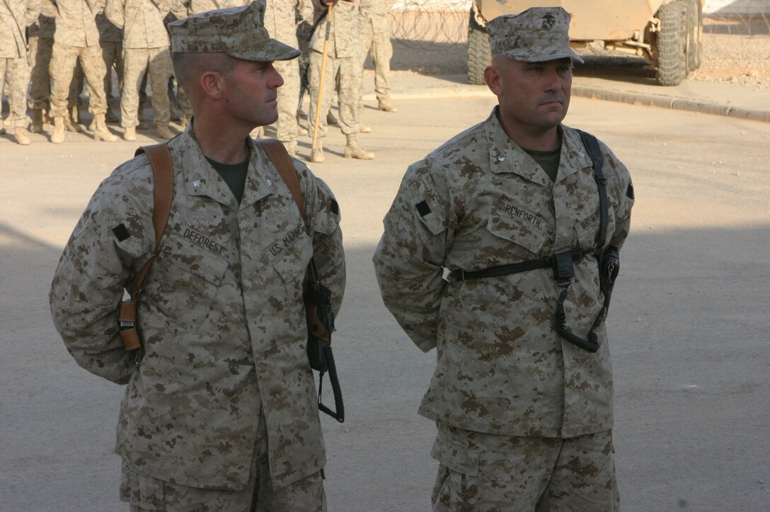 Marines and Sailors from 2nd Light Armored Reconnaissance Battalion, Regimental Combat Team-2, gather for a change of command ceremony.  Lt. Col. Richard A. Deforest hands command of 2d LAR to Lt. Col. Austin E. Renforth during a ceremony July 5, at Camp Korean Village, Iraq.