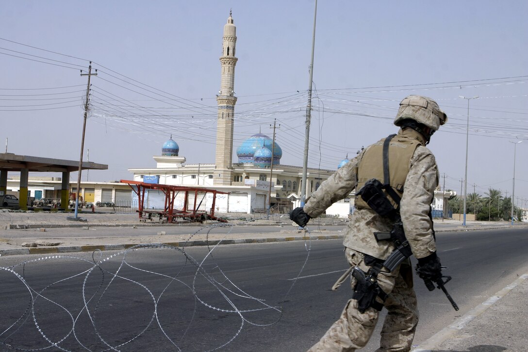 FALLUJAH, Iraq - Sgt. Amos Miller, an infantryman with 2nd Combined Anti-Armor Team, Weapons Company, 1st Battalion, 6th Marine Regiment, wires off a street here July 19 during Operation Rolling Barrage.  Weapons Company personnel worked alongside 1st Battalion, 6th Marine Regiment infantrymen, Iraqi Security Forces and mechanized supporting elements to block off sections of Fallujah, while roving infantrymen patrolled through the streets to disrupt insurgent activity.
