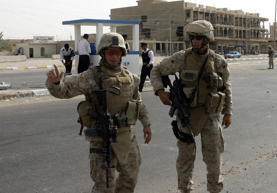 FALLUJAH, Iraq - Sgt. Amos Miller, an infantryman with 2nd Combined Anti-Armor Team, Weapons Company, 1st Battalion, 6th Marine Regiment, right, and 1st Lt. Frank Mease, 2nd CAAT commander, discuss how to best set up a defensive perimeter here July 19 during Operation Rolling Barrage. Weapons Company personnel worked alongside 1st Battalion, 6th Marine Regiment infantrymen, Iraqi Security Forces and mechanized supporting elements to block off sections of Fallujah, while roving infantrymen patrolled through the streets to disrupt insurgent activity.