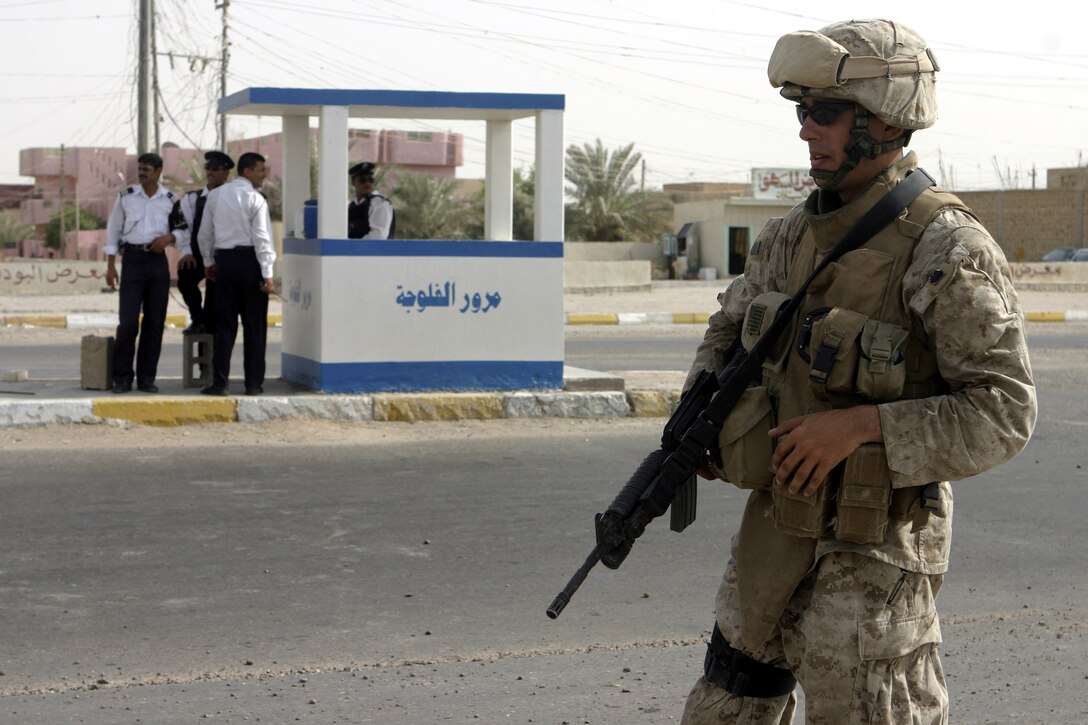 FALLUJAH, Iraq - Sgt. Amos Miller, an infantryman with 2nd Combined Anti-Armor Team, Weapons Company, 1st Battalion, 6th Marine Regiment, provides security along an intersection here during Operation Rolling Barrage.  Weapons Company personnel worked alongside 1st Battalion, 6th Marine Regiment infantrymen, Iraqi Security Forces and mechanized supporting elements to block off sections of Fallujah, while roving infantrymen patrolled through the streets to disrupt insurgent activity.