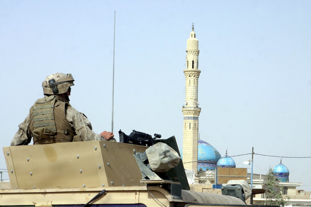 FALLUJAH, Iraq - A Marine with 2nd Combined Anti-Armor Team, Weapons Company, 1st Battalion, 6th Marine Regiment provides area security from atop his vehicle's gun turret here July 19 during Operation Rolling Barrage.  Weapons Company personnel worked alongside 1st Battalion, 6th Marine Regiment infantrymen, Iraqi Security Forces and mechanized supporting elements to block off sections of Fallujah, while roving infantrymen patrolled through the streets to disrupt insurgent activity.
