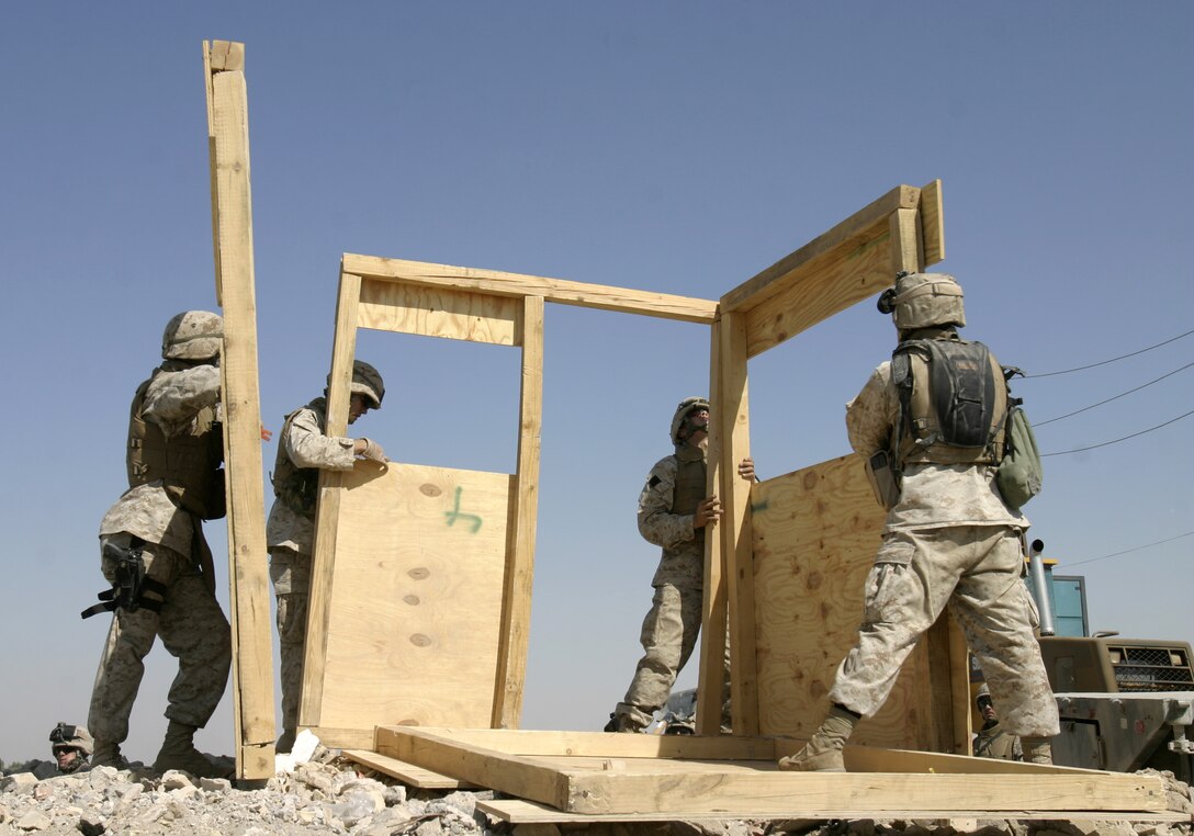 FALLUJAH, Iraq - Marines with 2nd Platoon, Company A, 2nd Combat Engineer Battalion put up wooden walls for a new observation post along the Euphrates River here Sept. 5.  Iraqi soldiers will man Observation Post Kilpela to monitor the city streets and riverbed's farm fields for insurgent activity, to include the placement of improvised explosive devices.