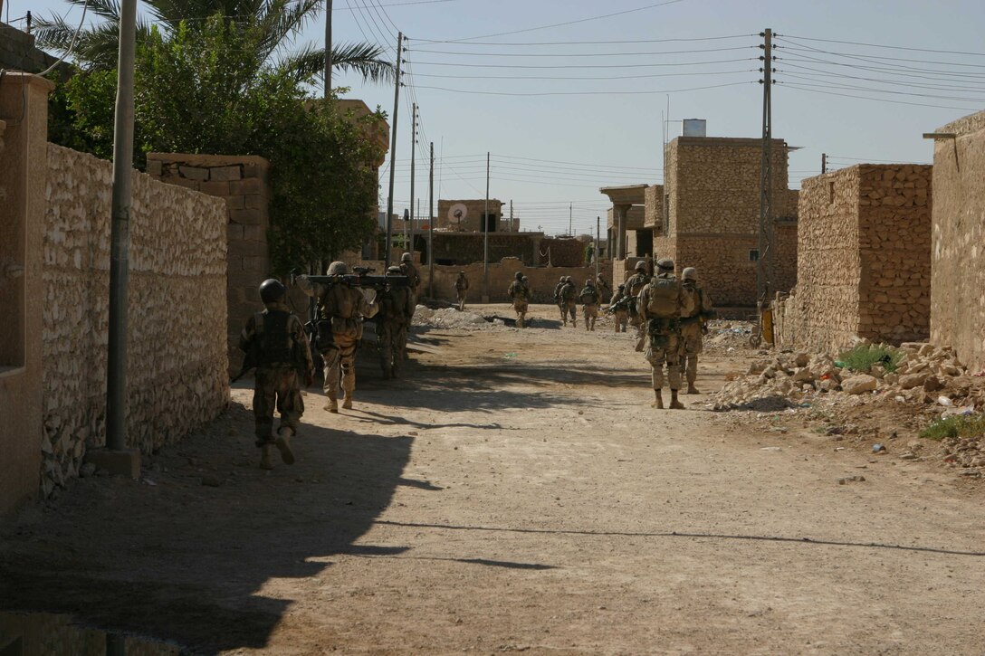 HADITHA, Iraq ? Marines with Company L, 3rd Battalion, 1st Marine Regiment and Iraqi security force soldiers patrol the streets here during operations to clear the city Oct. 5. Met with little resistance, the Marines and Iraqi soldiers are clearing the city of the remains of insurgent activities in the area. In only a few days, they have rid the city of many landmines, weapons caches and improvised explosive devices in an effort to take back the town that in the recent past has killed over a dozen U.S. Marines.