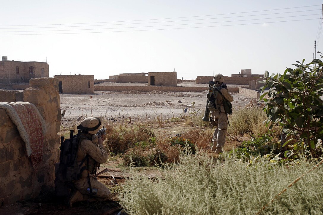 Husaybah, Iraq ( November 5, 2005)--Scouts with 2nd platoon, 1st LAR stand security outside a house that was booby trapped. They discovered it while conducting house searches as part of Operation Steel Curtain. (Official U. S. Marine Corps photo by Corporal Ken Melton)