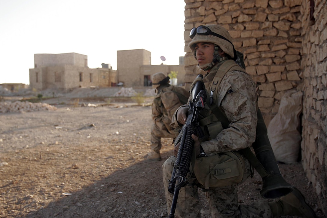 Husaybah, Iraq ( November 5, 2005)--Scouts with 2nd platoon, 1st LAR stand security outside a house while others search inside as part of Operation Steel Curtain. (Official U. S. Marine Corps photo by Corporal Ken Melton)