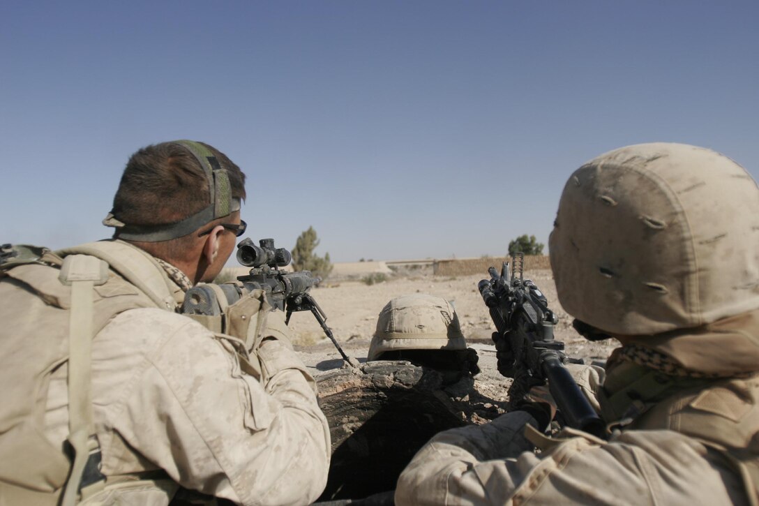 Husaybah, Iraq ( November 5, 2005)--Sgt. Robert E. Canales, 25, and Sgt. Saul Pando Jr., 23, scouts with 2nd platoon, 1st LAR stand security outside a house that was booby trapped. They discovered it while conducting house searches as part of Operation Steel Curtain. (Official U. S. Marine Corps photo by Corporal Ken Melton)
