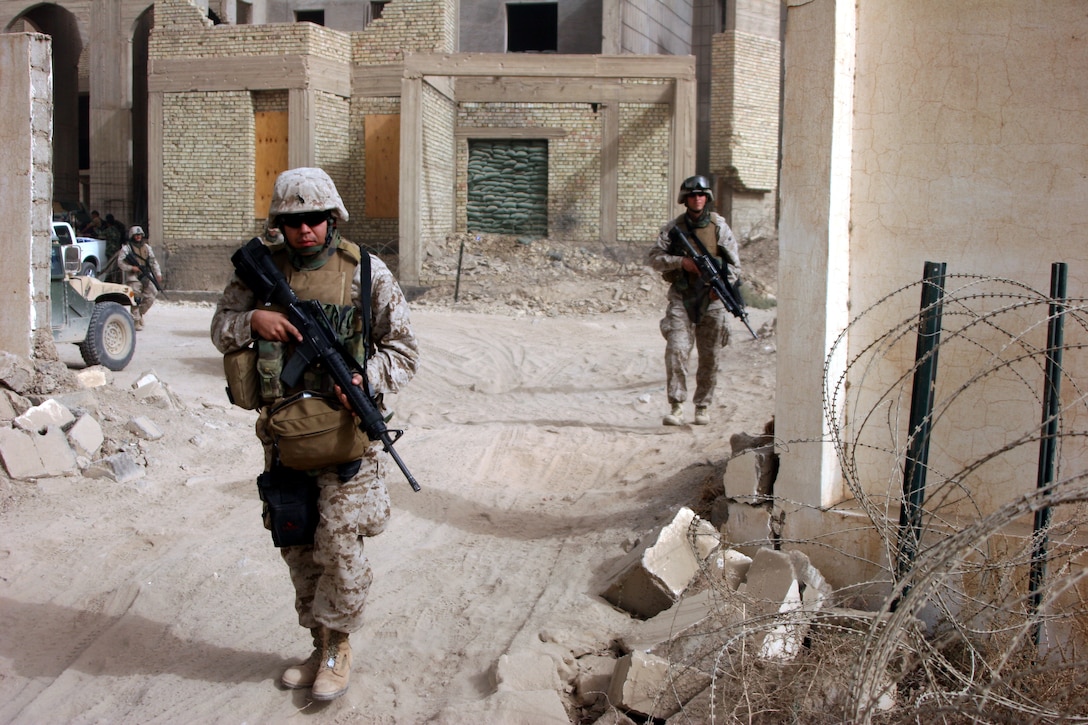 051105-M-8489S-007 AR RAMADI, Iraq (November 5, 2005) - Seaman Byron Rivera, a hospitalman with 3rd Battalion, 7th Marine Regiment, leaves Entry Control Point One during a civil affairs patrol Nov. 5. Photo by Cpl. Shane Suzuki