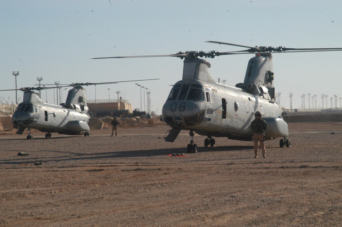 CH-46 Sea Knight helicopters prepare for a medical evacuation in the Al Anbar Province.  The 2nd Marine Division's Patient Evacuation Team constantly keeps tabs on how many beds are available, what necessary life-saving machines there are and what type of medical personnel work at each of the facilities throughout the province.  This kind of information saves time and lives as it prevents unnecessary trips to facilities that may already be filled with patients or ones with broken equipment. photo courtesey of Lt. James Morris.