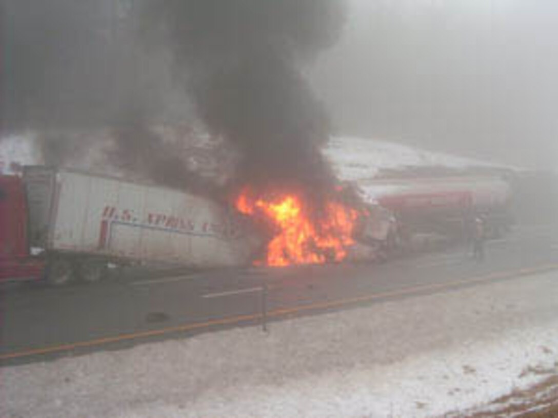 Pvt. James Stewart and an unidentified truck driver pull 57-year-old Cornelius J. Mahar from his burning tractor-trailer cab after it collided with another vehicle Monday on Interstate 87 in New York. Also pictured is Pfc. Charles Meskunas who helped drag Mahar to safety. Not pictured are Pfc. William Patnode and Pfc. Gregory Lafountain who dropped off Meskunas and Stewart and then went to call for help. All four Marines are currently assigned to Recruiting Station Albany, N.Y., on the Permissive Recruiters Assistance Program. The Marines were on their way to RS Albany for recruiters? assistance training when they happened upon the accident.