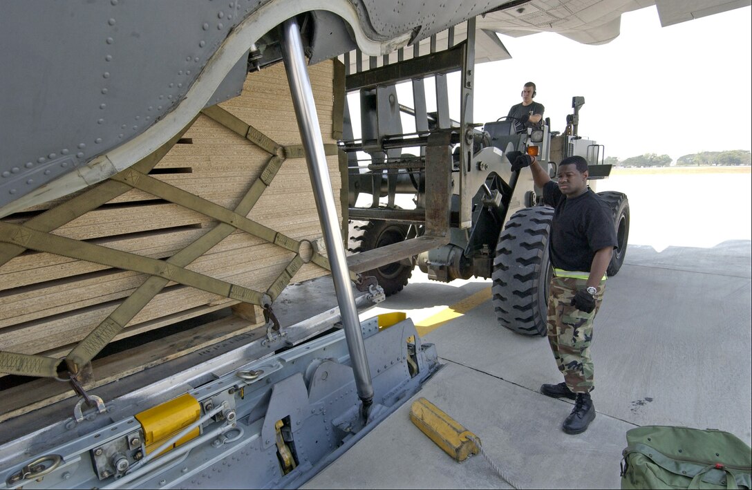 BANGKOK INTERNATIONAL AIRPORT, Thailand -- Staff Sgt. Billy Lucas guides a pallet of relief supplies on a C-130 Hercules from Kadena Air Base, Japan here recently. Sergeant Lucas is an air transportation craftsman with the 733 Air Mobility Squadron at Kadena and is deployed to Thailand in support of the international tsunami relief efforts in Asia. (U.S. Air Force photo by Tech. Sgt. John M. Foster)