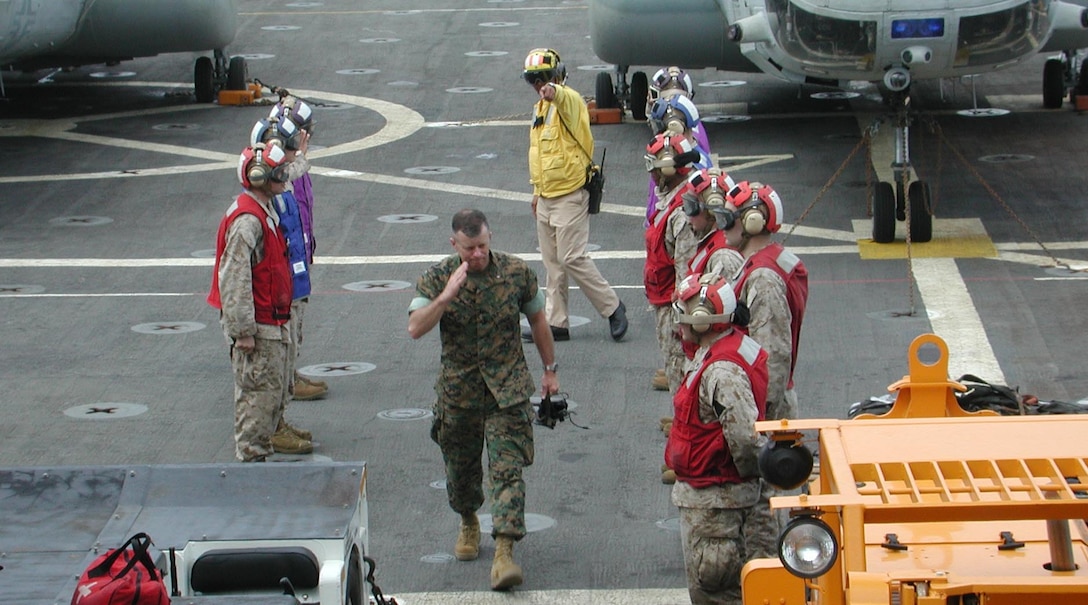 Brigadier General Frank A. Panter Jr. is saluted by Marines of the 15th Marine Expeditionary Unit (Special Operations Capable) as he boards the USS Duluth off the coast of Sri Lanka.  The 15th Marine Expeditionary Unit (Special Operations Capable) provided desperately needed humanitarian aid to cities and villages along Sri Lanka's southern coastline.