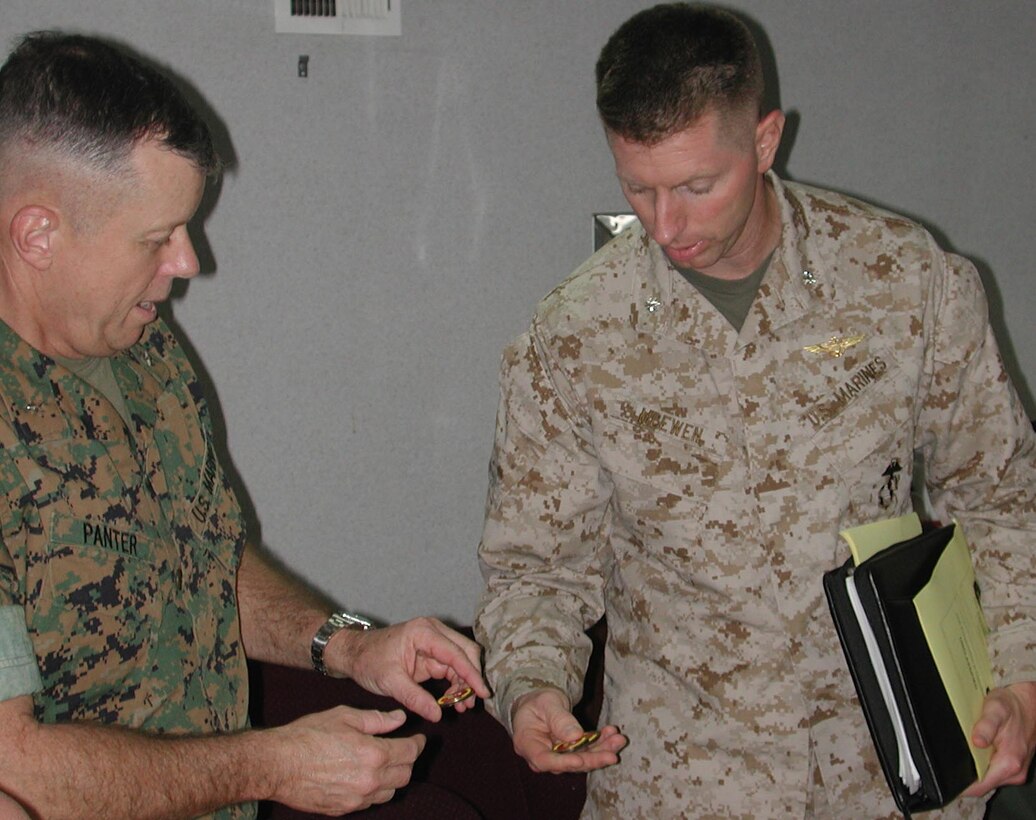 LtCol Matthew D. McEwen executive officer of the 15th Marine Expeditionary Unit (Special Operations Capable) hands Brig. Gen. Frank A. Panter commanding officer of 3rd Force Service Support Group a 15th MEU CO's coin.  The 15th Marine Expeditionary Unit (Special Operations Capable) provided desperately needed humanitarian aid to cities and villages along Sri Lanka's southern coastline.