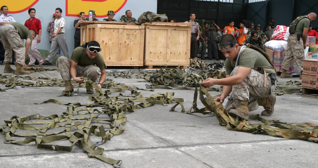 MEDAN Indonesia (Jan. 5, 2005) -- Marines with the 15th Marine Expeditionary Unit (Special Operations Capable) prepare humanitarian aid supplies to be flown to the USS Bonhomme Richard. The 15th MEU (SOC) is scheduled to tansport the supplies to the west side of Sumatra and distribute them to the victims of the recent tsunami. (Official USMC photo by Lance Corporal Scott L. Eberle)