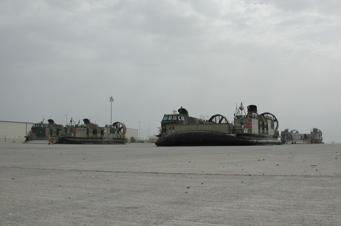 Three Landing Craft Air Cushioned wait to load Marines and vehicles during a unit wash down.  The 15th Marine Expeditionary Unit (Special Operations Capable) recently completed their second combat tour in Iraq.