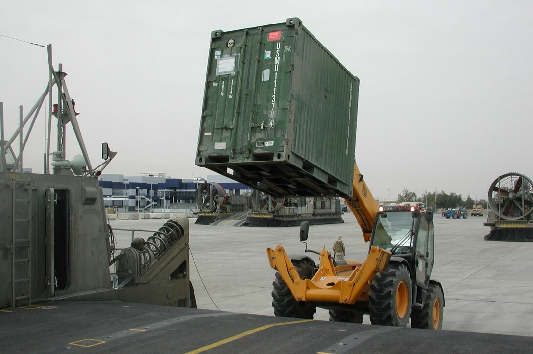 A forklift operator moves a quadcon onto the deck of a Landing Craft Air Cushioned.  The 15th Marine Expeditionary Unit (Special Operations Capable) recently completed their second combat tour in Iraq.