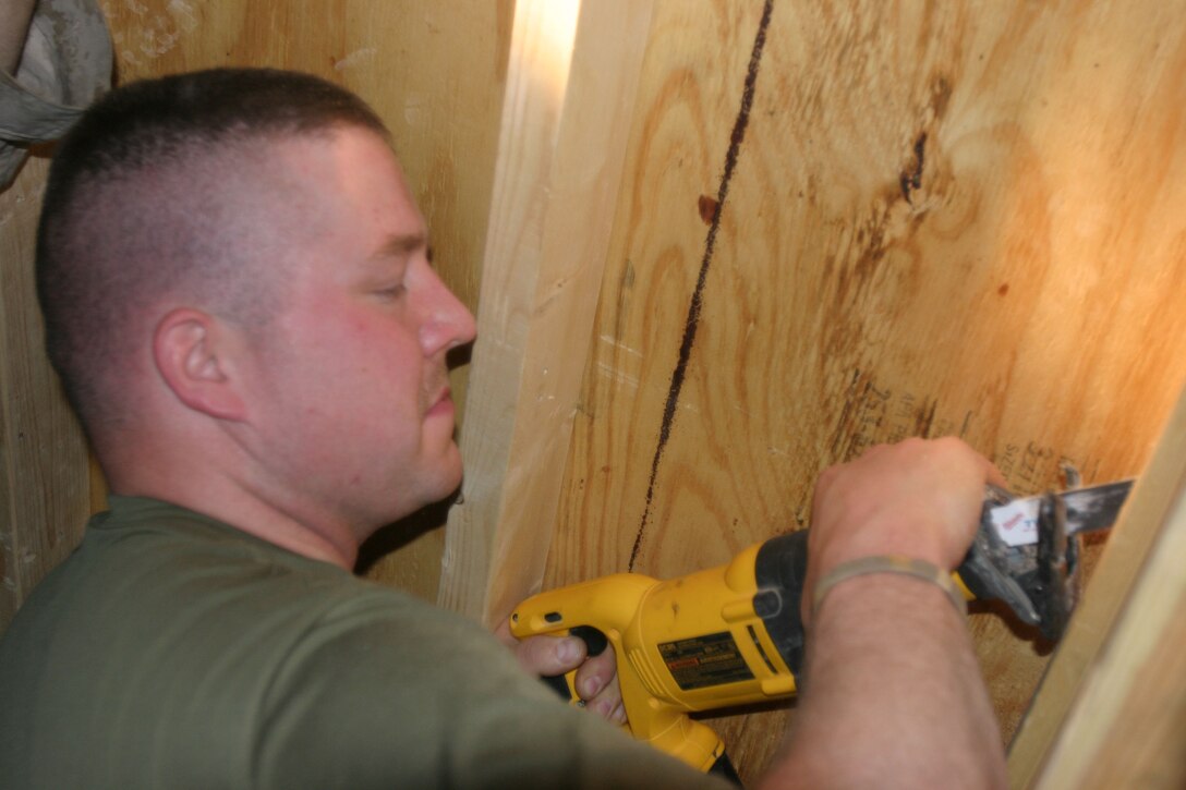 CAMP AL QAIM, Iraq (March 6, 2005)- Lance Cpl. Kevin D. Taylor, 28, a machine gunner with 3rd Battalion, 2d Marine Regiment works on making his living area more comfortable. The Warren, Ohio, native gave up his own construction business to join the Marine Corps and still uses those skills today. Official U.S. Marine Corps photo by Lance Cpl. Lucian Friel (RELEASED)