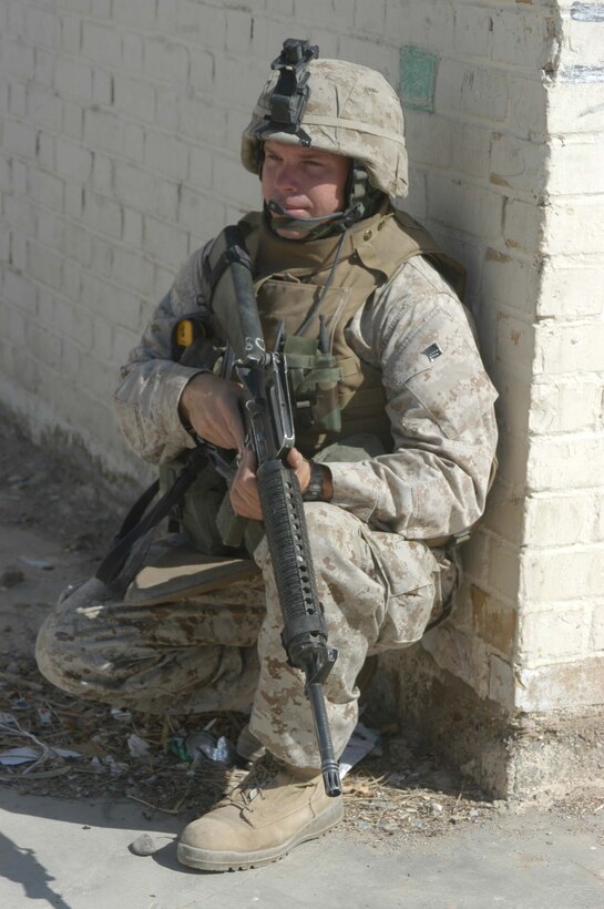 AR RAMADI, Iraq (May 26, 2005) - Sergeant Charles F. Crellin, a rifleman and the training noncommissioned officer for Company C, 1st Battalion, 5th Marine Regiment, provides security at the Al Jaod Elementary School here during a civil affairs mission with 4th Platoon, Company C and Marines with Team 1, Detachment 3, 5th Civil Affairs Group, which is direct support of the infantry battalion. The 28-year-old from Cincinnati and his fellow Marines surveyed the school and determined what repairs and supplies are needed. Photo by: Cpl. Tom Sloan