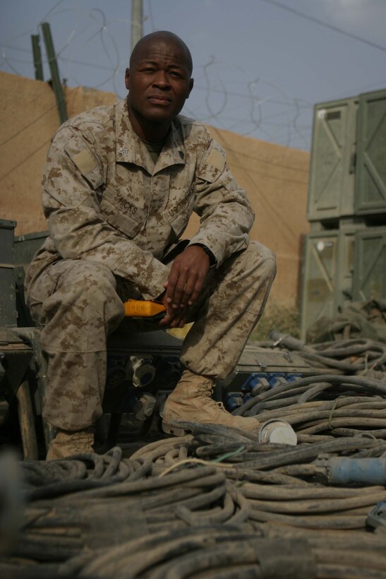 CAMP BLUE DIAMOND, RAMADI, Iraq - Sergeant Derrick L. Hicks, an electrical equipment repairman, Headquarters Battalion, 2nd Marine Division, provides the electricity that keeps the 2nd Marine Division's Communications Company up and running. Communications Company provides the main conduit for all internet, phone and radio communications flowing into and out of the camp which houses the 2nd Marine Division's Headquarters. Official U.S. Marine Corps photo by Sgt. Ryan S. Scranton