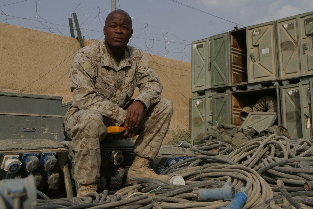 CAMP BLUE DIAMOND, RAMADI, Iraq - Sergeant Derrick L. Hicks, an electrical equipment repairman, Headquarters Battalion, 2nd Marine Division, provides the electricity that keeps the 2nd Marine Division's Communications Company up and running. Communications Company provides the main conduit for all internet, phone and radio communications flowing into and out of the camp which houses the 2nd Marine Division's Headquarters. Official U.S. Marine Corps photo by Sgt. Ryan S. Scranton