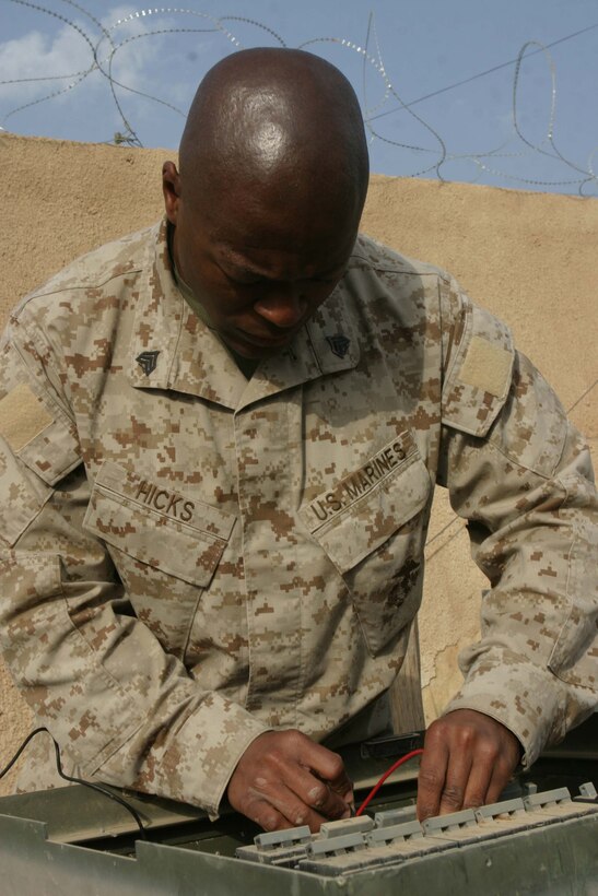 CAMP BLUE DIAMOND, RAMADI, Iraq - Sergeant Derrick L. Hicks, an electrical equipment repairman, Headquarters Battalion, 2nd Marine Division, test the voltage on a power distribution box here. Hicks provides the electricity that keeps the 2nd Marine Division's Communications Company up and running. Communications Company provides the main conduit for all internet, phone and radio communications flowing into and out of the camp which houses the 2nd Marine Division's Headquarters. Official U.S. Marine Corps photo by Sgt. Ryan S. Scranton