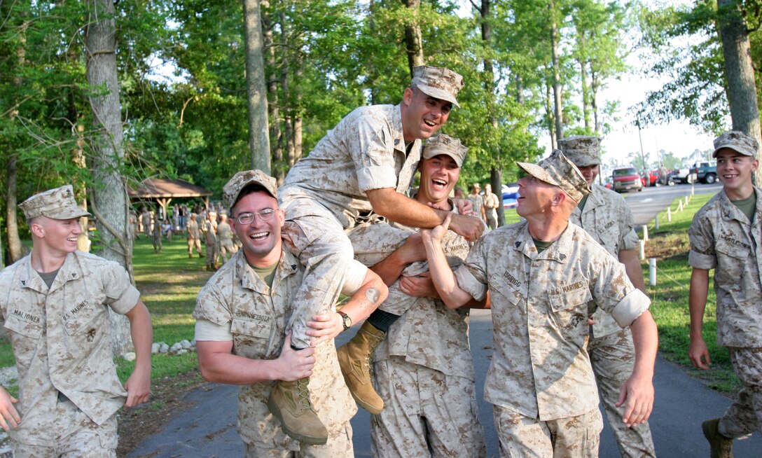 As part of a time-honored tradition, Gunnery Sgt. Alvin W. Thomas, former first sergeant of Small Craft Company, is escorted to the water for a final swim.  After 20 years in the Marine Corps, many of which were spent at Small Craft Company, he retired June 6 during the company's decomissioning ceremony.