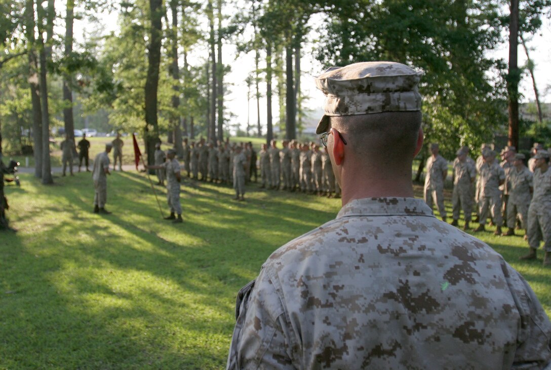 Gunnery Sgt. Brian A. Vinciguerra, the company first sergeant for Small Craft Company, looks on as the company's guidon is retired.  After more than 14 years with the only amphibious assault company of its kind in any American armed service, he watched as the company was officially decomissioned during a ceremony June 6.