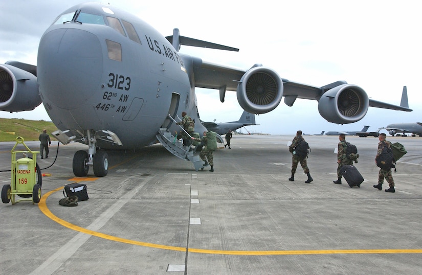 KADENA AIR BASE, Japan -- A team from several squadrons here board a C-17 Globemaster III for a 45-day deployment to Sri Lanka.  The team deployed as part of disaster relief following the 9.0 magnitude earthquake that struck off the coast of Indonesia causing tsunami waves that have affected 12 countries and has killed more than 150,000 people. The 18th Wing is providing relief supplies and personnel to help with the humanitarian effort. The team is composed of Airmen form the base's 718th Aircraft Maintenance Squadron, 33d Aircraft Maintenance Unit, 33rd Rescue Squadron, 18th Logistics Readiness Squadron, and 18th Maintenance Squadron. (U.S. Air Force photo by Airman 1st Class Michael Pallazola)