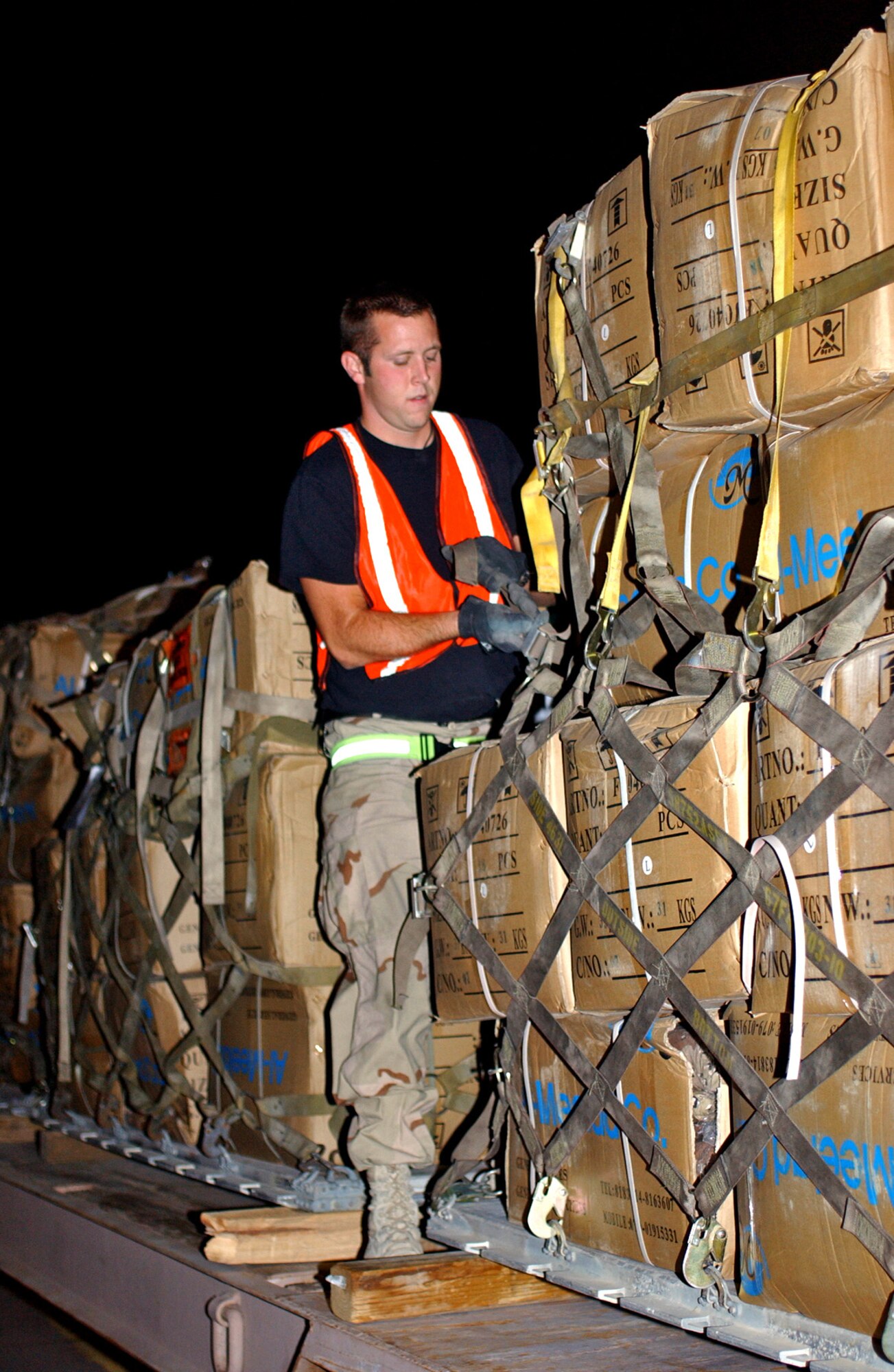 SOUTHWEST ASIA -- Senior Airman Ronnie Hearne prepares a pallet to be loaded on an aircraft.  He is an air transportation specialist with the 380th Expeditionary Logistics Readiness Squadron. (U.S. Air Force photo by Tech. Sgt. Erik Gudmundson)
