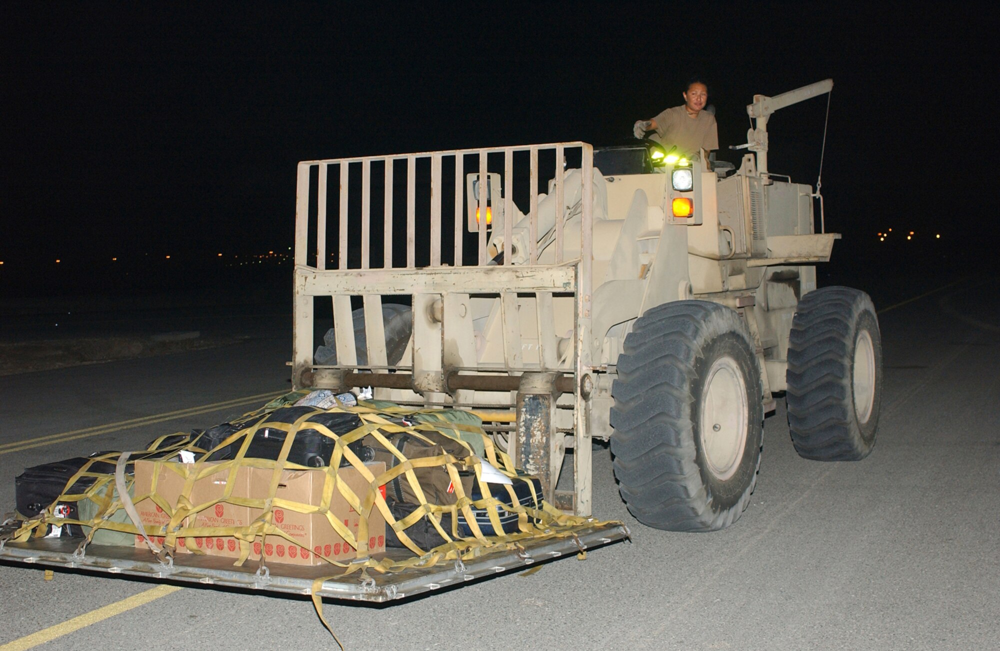 SOUTHWEST ASIA -- Senior Airman Laura Caballero uses a forklift to load a pallet on an aircraft.  She is an air transportation specialist with the 380th Expeditionary Logistics Readiness Squadron. (U.S. Air Force photo by Tech. Sgt. Erik Gudmundson)