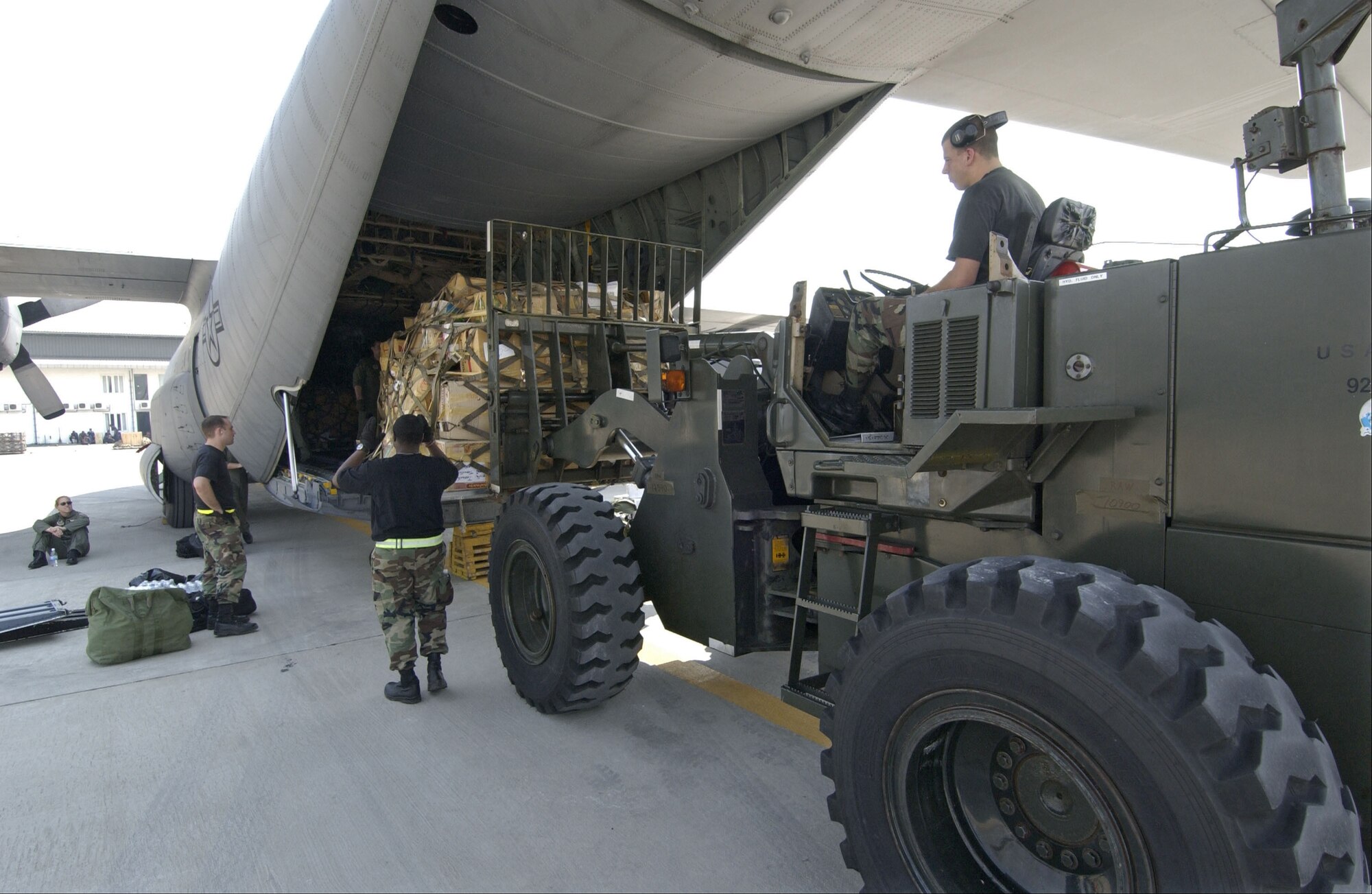 BANGKOK, Thailand -- Airmen from the 733rd Air Mobility Squadron at Kadena Air Base, Japan, load a pallet of relief supplies onto a C-130 Hercules at the international airport here Jan. 4.  (U.S. Air Force photo by Tech. Sgt. John M. Foster) 