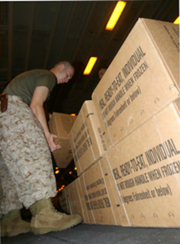 U.S. Marine Corps Lance Cpl. Dustin L. Folkes prepares pallets of Meals Ready-to-Eat for shipment to the tsunami-stricken area while aboard the USS Bonhomme Richard (LHD 6) on Jan. 1, 2005. U.S. service men and women are working to deliver humanitarian relief supplies and provide medical assistance to the tsunami-stricken countries as part of Operation Unified Assistance. Folkes is assigned as an administrative clerk with the 15th Marine Expeditionary Unit Special Operations Capable. 