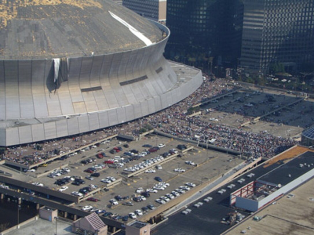 Evacuees line up to vacate the damaged New Orleans Superdome due to Katrina.
