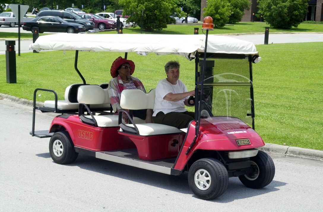 MARINE CORPS BASE CAMP LEJEUNE, N.C. ? Karen L. Allison, a Red Cross volunteer, shuttles a hospital patron to the entrance from her parking space here June 6. The eight-passenger patient shuttle, available at the Camp Lejeune Naval Hospital to assist patients from their cars to the building, has been a great success since its debut April 18. (Official Marine Corps photo by Lance Cpl. Brandon R. Holgersen)