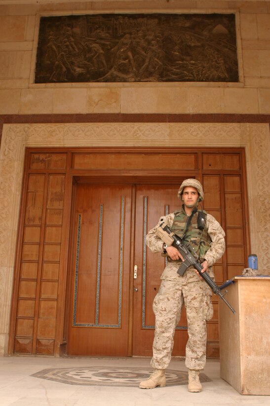 Private First Class Augustin Melendez, a 22-year-old special intelligence communicator and administrator with 2d Radio Battalion, 2d Marine Division, stands guard outside of the division's combat operations center.  The Roselle Park, N.J. native rotates between guarding the COC, where all 2d Marine Division missions are tracked, to handling insurgent detainees and even guarding the mess hall while Marines and other service members eat.  Melendez is one of the Marines on the camp's security force, keeping an eye out for anything suspicious - day or night.  Official U.S. Marine Corps photo by Sgt. Stephen D'Alessio (RELEASED)