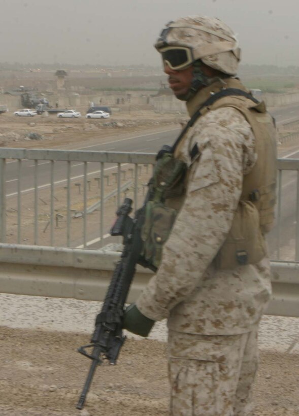 CAMP ABU GHURAYB, IRAQ – Lance Cpl. Jonathan C. Nelson, a Brooklyn, N.Y., native watches as he patrols over a bridge just outside of the Abu Ghurayb Prison.  Recently insurgents attacked the prison where Company K provided a quick reaction force fighting off the attacks keeping the prison safe.  Official U.S. Marine Corps photo by Lance Cpl. Athanasios L. Genos