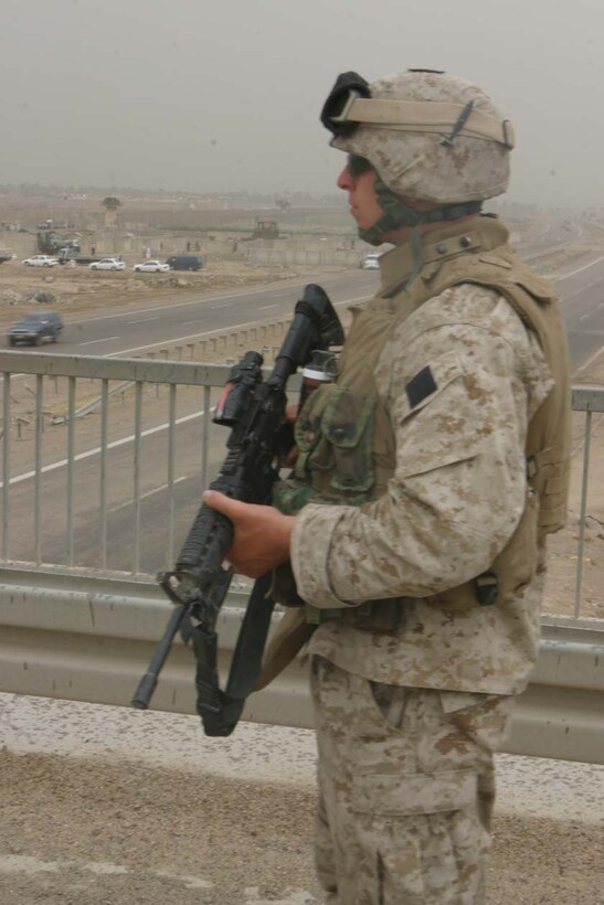 CAMP ABU GHURAYB, IRAQ – Lance Cpl. Ronald G. Kramer, a Pittsburgh, Pa., native watches as he patrols over a bridge just outside of the Abu Ghurayb Prison.  Recently insurgents attacked the prison where Company K provided a quick reaction force fighting off the attacks keeping the prison safe.  Official U.S. Marine Corps photo by Lance Cpl. Athanasios L. Genos