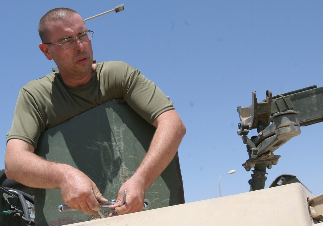 Hadithah Dam, Al Anbar, Iraq.-- Staff Sgt. Richard W. Watkins, 32, works on a ring-mounted gun turret on a HMMWV.  Watkins is a 2/14 motor transport chief from Pearl, Miss.  The turrets can be fitted with the M2 .50 caliber machine gun, M240G, or the MK19 automatic grenade launcher.  (Photo by LCpl. Marc Fencil. )