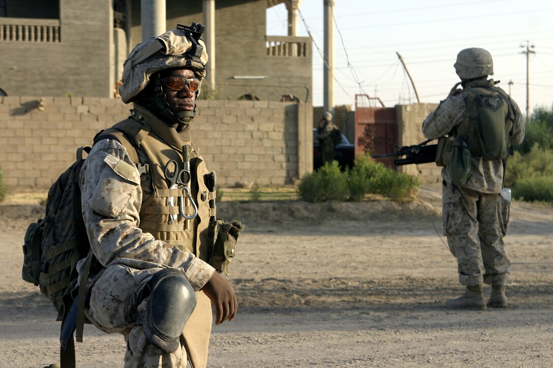 SAQLAWIYAH, Iraq – Seaman Clarence Washington, a corpsman with 4th Platoon, Company A, 1st Battalion, 6th Marine Regiment, provides security while patrolling the streets here July 27.  The 26-year-old Caruthersville, Mo. native is one of several ‘docs’ who live and work alongside the infantrymen here, administering first aid in combat and treating acute illnesses.