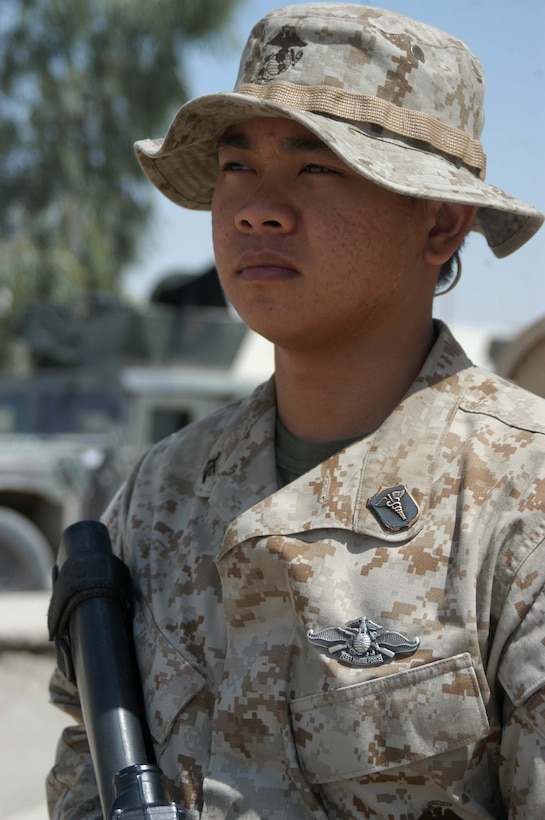CAMP HURRICANE POINT Ar Ramadi, Iraq (Aug. 2, 2005) - Petty Officer 3rd Class Francis P. Manaloto, a hospitalman with 3rd Platoon, Company W, 1st Battalion, 5th Marine Regiment, recently earned his Fleet Marine Force pin and was awarded it during a ceremony here July 24. The 21-year-old from Sinjana, Guam used every chance he had to study the FMF books so he could pass the test. When he wasn't on missions in the Al Anbar capital with his Marine comrades, he devoted three hours of his time each day for a month to studying. Earning the FMF pin symbolizes his knowledge of Navy and Marine Corps history, customs and courtesies and Marine Corps and amphibious operations. Manaloto enlisted in the Navy after graduating from John F. Kennedy High School in 2002 so he could see the world and someday attend college. This is his second deployment to Iraq supporting Operation Iraqi Freedom in as many years. Photo by: Cpl. Tom Sloan