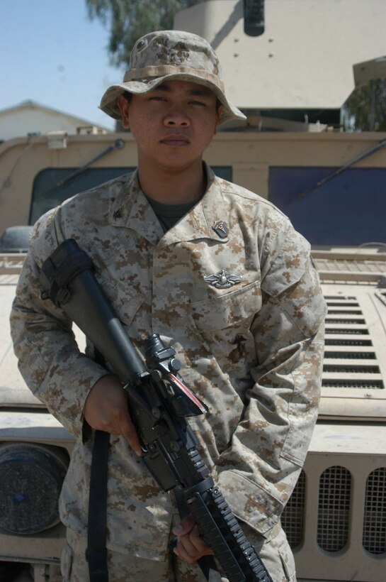 CAMP HURRICANE POINT Ar Ramadi, Iraq (Aug. 2, 2005) - Petty Officer 3rd Class Francis P. Manaloto, a hospitalman with 3rd Platoon, Company W, 1st Battalion, 5th Marine Regiment, recently earned his Fleet Marine Force pin and was awarded it during a ceremony here July 24. The 21-year-old from Sinjana, Guam used every chance he had to study the FMF books so he could pass the test. When he wasn't on missions in the Al Anbar capital with his Marine comrades, he devoted three hours of his time each day for a month to studying. Earning the FMF pin symbolizes his knowledge of Navy and Marine Corps history, customs and courtesies and Marine Corps and amphibious operations. Manaloto enlisted in the Navy after graduating from John F. Kennedy High School in 2002 so he could see the world and someday attend college. This is his second deployment to Iraq supporting Operation Iraqi Freedom in as many years. Photo by: Cpl. Tom Sloan