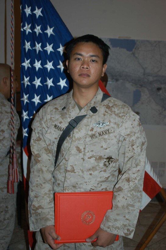 CAMP HURRICANE POINT Ar Ramadi, Iraq (Aug. 2, 2005) - Petty Officer 3rd Class Francis P. Manaloto, a hospitalman with 3rd Platoon, Company W, 1st Battalion, 5th Marine Regiment, recently earned his Fleet Marine Force pin and was awarded it during a ceremony here July 24. The 21-year-old from Sinjana, Guam used every chance he had to study the FMF books so he could pass the test. When he wasn't on missions in the Al Anbar capital with his Marine comrades, he devoted three hours of his time each day for a month to studying. Earning the FMF pin symbolizes his knowledge of Navy and Marine Corps history, customs and courtesies and Marine Corps and amphibious operations. Manaloto enlisted in the Navy after graduating from John F. Kennedy High School in 2002 so he could see the world and someday attend college. This is his second deployment to Iraq supporting Operation Iraqi Freedom in as many years. Photo by: Cpl. Tom Sloan