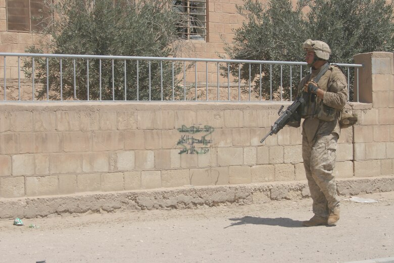 BANI DAHRI, Iraq (July 13, 2005)- Lance Cpl. Raphael P. Ramos, 21, from Carolina, Puerto Rico and a squad automatic weapon gunner with 1st Squad, 3rd Platoon, Company K, 3rd Battalion, 2nd Marine Regiment, Regimental Combat Team-2 patrols through the city during Operation Quick Strike. The 2003 Ana Roque High School graduate is making his first deployment in support of Operation Iraqi Freedom and has decided to continue his career and become a Marine Corps officer. (Official USMC photo by Lance Cpl. Lucian Friel )(RELEASED)
