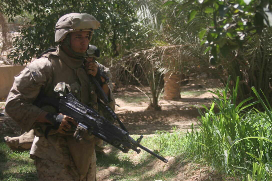 BANI DAHRI, Iraq (July 13, 2005)- Lance Cpl. Raphael P. Ramos, 21, from Carolina, Puerto Rico and a squad automatic weapon gunner with 1st Squad, 3rd Platoon, Company K, 3rd Battalion, 2nd Marine Regiment, Regimental Combat Team-2 patrols through a wadie in the city during Operation Quick Strike. The 2003 Ana Roque High School graduate is making his first deployment in support of Operation Iraqi Freedom and has decided to continue his career and become a Marine Corps officer. (Official USMC photo by Lance Cpl. Lucian Friel )(RELEASED)